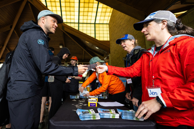 Jen Checking In Runners - Photo Credit Scott Rokis